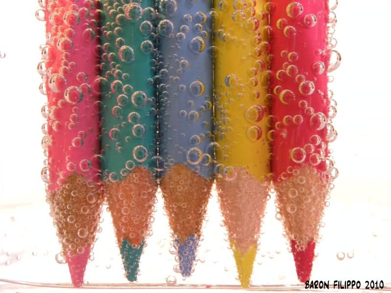 Photo of colored pencils in sparkling water